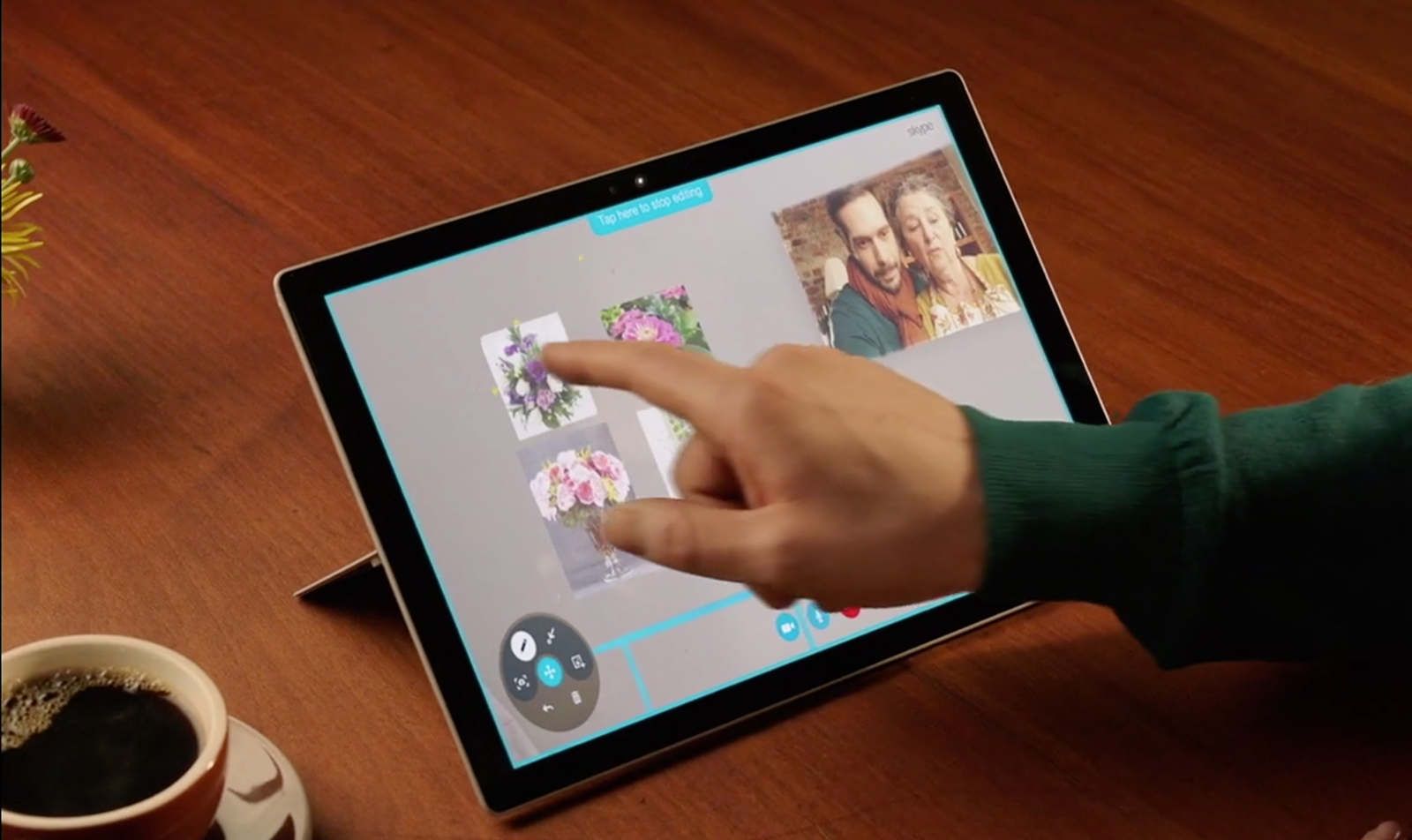 Remote Skype participant using a Microsoft Surface tablet to reorient objects in the holographic space.